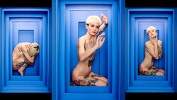 Three figures posed within nested blue rectangular frames, displaying creative portraiture and spatial composition.
