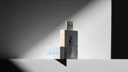 Artistic composition of a USB drive with photo printing mounted on wooden blocks against dramatic shadow lighting.