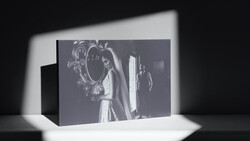 Black and white photograph displayed as a 3D printed or sculptural object with dramatic directional lighting casting shadows.