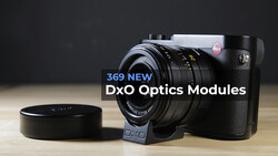 DxO camera with interchangeable lens module and lens cap on wooden surface.