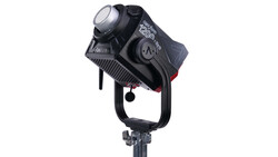 Black professional LED spotlight with adjustable head mounted on a stand against white background.