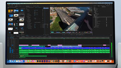 Screenshot of video editing software with aerial footage of a waterway and industrial area in the center canvas.
