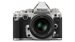 Nikon Df DSLR camera with silver top plate and black body, featuring a standard prime lens with green optical elements visible.