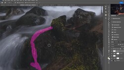 Screenshot of Photoshop editing interface with a landscape photograph of a flowing stream and mossy rocks, with a magenta curved selection tool visible.