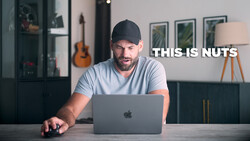 Man at desk with laptop reacting with an expression of disbelief while text overlay reads 'THIS IS NUTS'.