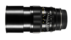 Black telephoto lens with manual focus ring and aperture scale markings.