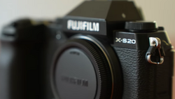 Fujifilm X-S20 mirrorless camera body shown from front-left angle, highlighting the textured grip and control layout.