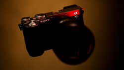 Sony Alpha 7C mirrorless camera shot from above against warm studio lighting with shadow.