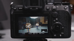 Screenshot of a mirrorless camera's rear LCD screen displaying live view with exposure settings overlay.