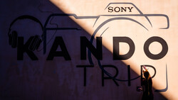 Graphic composition featuring Sony camera icon, headphones, microphone, and text overlay on warm and cool toned background.