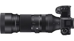 Mirrorless camera with telephoto lens attached, shown in profile against white background.