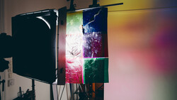 Professional lighting setup with black flag reflector and multicolored LED panels mounted on a rigging system.