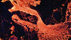 Aerial thermal or infrared view of flowing lava with bright orange and yellow channels against dark cooled rock.