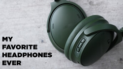 Pair of green over-ear headphones with fabric ear cups displayed on a light textured surface.