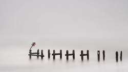 Tally marks etched into snow with a small figurine standing at the leftmost mark.