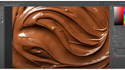 Close-up of swirled chocolate texture with glossy highlights and smooth peaks.