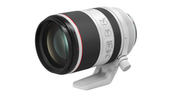 White and black telephoto lens with built-in tripod collar and focus ring controls.