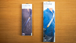 Two product packaging boxes for camera slide accessories displayed on a wooden surface.