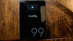 SmallRig 99 portable power station displaying 0x charge status on wooden surface.