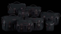 Collection of nine black camera bags and cases with brown leather accents arranged on a black background.