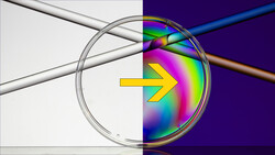 Illustration of light refraction through a spherical lens showing a colorful spectrum projection.