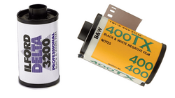 Two film canisters: a Ilford HP5 black and white 35mm film roll on the left, and a Kodak Portra 400 color negative film roll on the right.