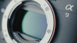Close-up of a mirrorless camera body showing the open lens mount with visible sensor and electronic contacts.
