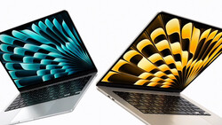 Two open laptops displaying colorful geometric feather wallpapers in turquoise and gold tones.