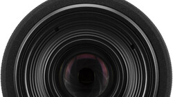 Close-up view of camera lens front element with concentric glass rings and internal reflections.