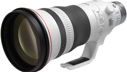 White telephoto lens with large front element and built-in tripod foot shown in profile view.