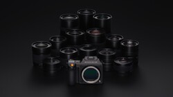 Medium format camera body surrounded by approximately 14 black prime lenses arranged in a pyramid formation.