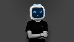 Person wearing black t-shirt with robot head featuring pixelated blue eyes display against gray background.