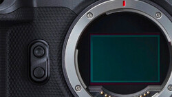 Mirrorless camera body with mount exposed and sensor visible, showing dual control dials on left grip.