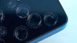 Close-up view of a smartphone's multi-lens camera module with four lenses and technical specifications printed on the dark back panel.