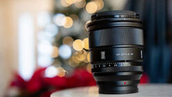 Sony AF 27/2.8 manual focus lens positioned in front of blurred holiday bokeh background.