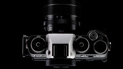 Top-down view of a rangefinder film camera with interchangeable lens mounted above.