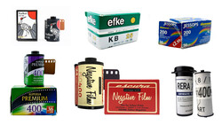 Collection of vintage film stock boxes and canisters arranged in rows.