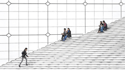 People scattered across a monumental staircase, some climbing, others sitting and socializing on the steps.