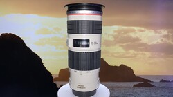 Canon EF 70-200mm f/2.8L telephoto lens displayed against a coastal sunset with rocky islands.