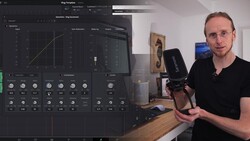 Man holding a microphone in a home studio with a computer displaying audio editing software on the left.