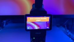DJI Osmo handheld gimbal displaying overheated recording stopped error message on its screen.