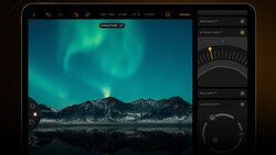 Screenshot of photo editing software showing aurora borealis over mountains with adjustment panels on right.