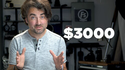 Man in gray henley shirt gestures while speaking in a studio with equipment shelving visible behind him and a $3000 price figure overlaid.