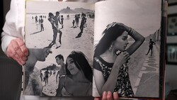 Open photography book displaying black and white beach portraits and candid shots across two pages.