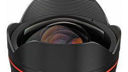 Wide-angle lens with red accent ring and lens hood, viewed from front showing glass elements.