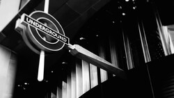 London Underground sign suspended from ceiling in high-contrast black and white.