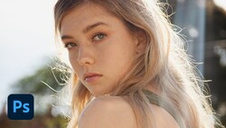 Portrait of a young woman with blonde hair in golden hour sunlight, looking over her shoulder.