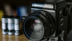 Mamiya RB67 Pro II medium format camera with standard lens on wooden surface.