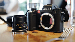 Leica SL2 camera body with 35mm lens on wooden surface.