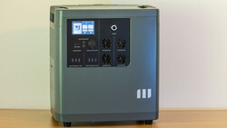 Portable power station with digital display and control panel on wooden surface.